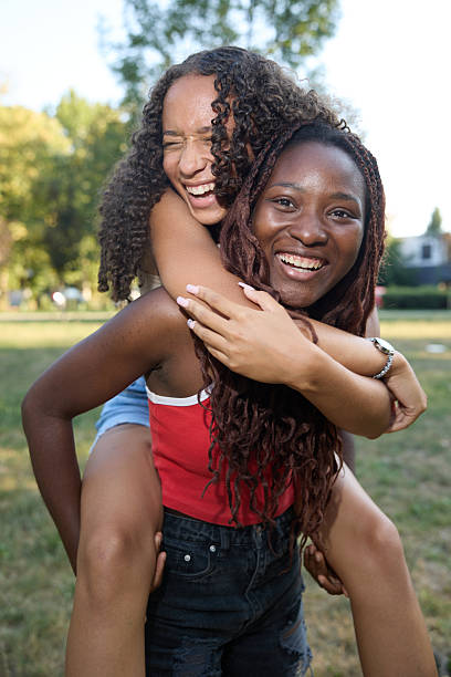istock Joyful Teens Sharing Laughter and Friendship in a Sunny Park Setting 2244027917