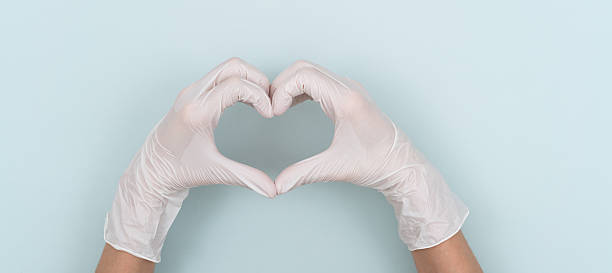 istock Making a heart shape with hands wearing disposable gloves 2244032970