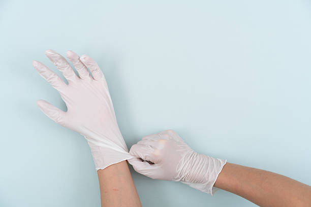 istock Hands wearing white disposable gloves 2244033718