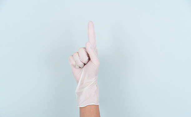 istock Making the number 1 gesture with a hand wearing a disposable glove 2244033766