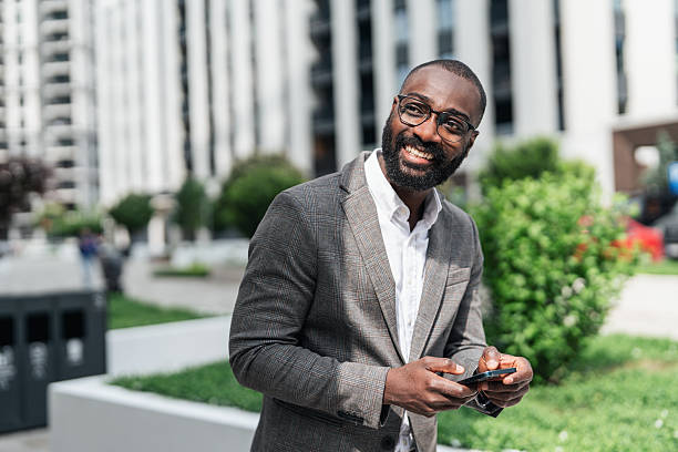 istock Cheerful businessman texting 2244033915