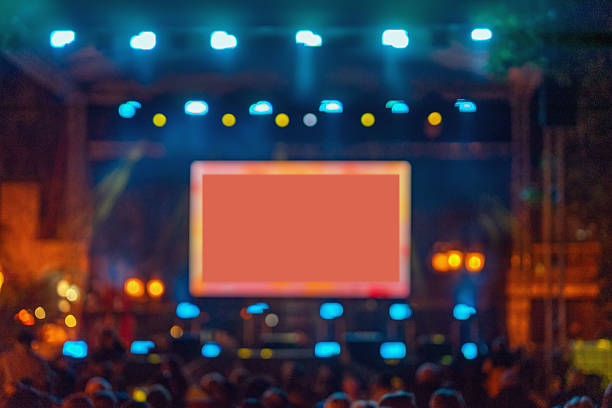 istock Blurred concert stage with glowing screen and bright lights, creating dynamic atmosphere with copy space for text or branding. Concept of live show, digital display, event 2244035514