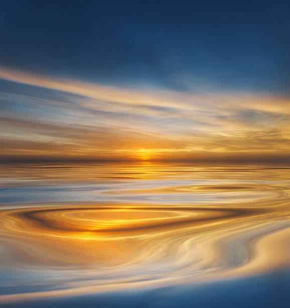 Tranquil ocean at sunset with golden reflections