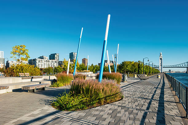 Park and promenade at the St Lawrence River waterfront in Old Port Montreal, Quebec, Canada.