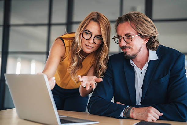istock Business colleagues communicating and collaborating in an office 2244041596