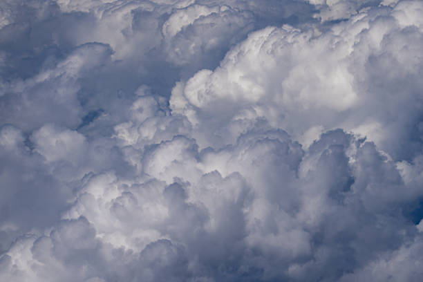 Blue sky with calm clouds background. Bright blue sky background. Cloudscape with white clouds. Calm sky cloudy on a summer day. Sunlight through the clouds wallpaper. Spring sky with soft clouds