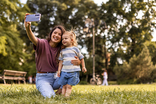 istock Mother and Daughter Taking Selfie in Golden Hour Light 2244043839