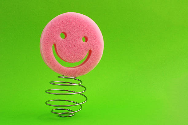 Happy sponge face balanced on a metal spiral, happiness overcomes problems