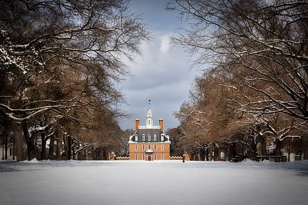 Williamsburg, Virginia, USA - February 20, 2025: A fresh snowfall on palace green and the reconstructed Governor's Palace.