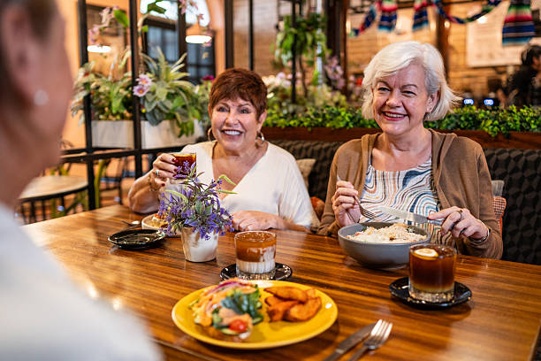 istock Senior friends women talking during lunch on restaurant 2244048838