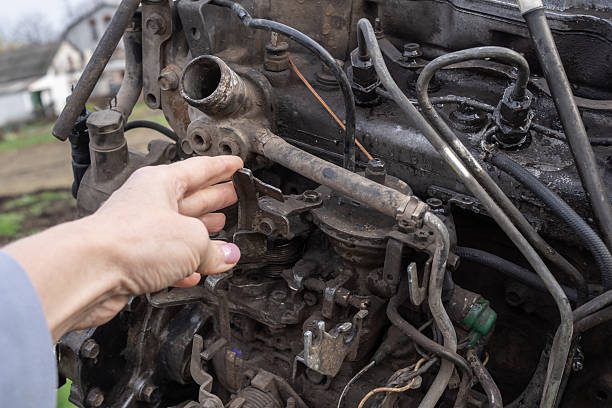 istock Mechanic inspecting engine parts during repair 2244049106