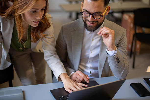 istock Business colleagues collaborating on laptop in a modern office 2244050253