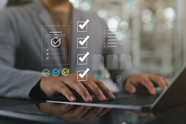 istock Automated document approval and quality control concept, Businessman verifies and manages digital paperwork on a laptop using a smart system before final task delivery. DMS concept. 2244051934