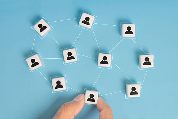 istock Building a strong team, dice with people icon on blue background, Human resources and management concept. 2244051973