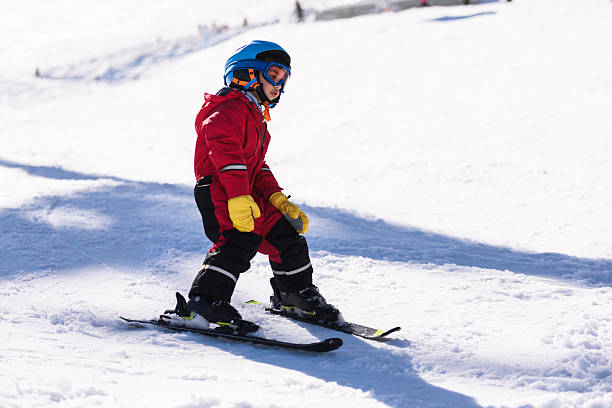 istock Child learning skiing on snowy mountain slope 2244053376