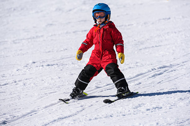 istock Young child learning skiing on winter snow slopes 2244053474