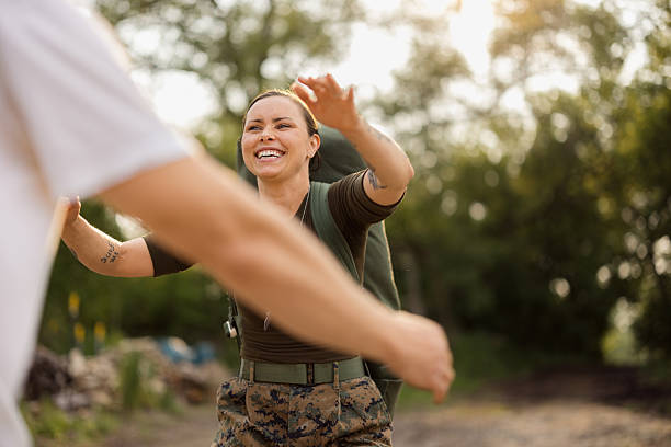 Military woman returning home embracing partner