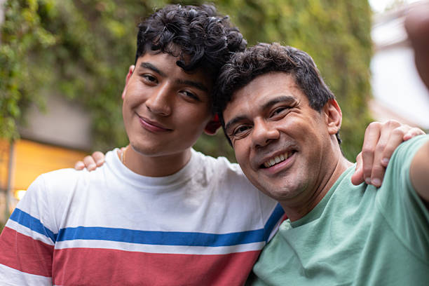 istock Hispanic father and son portrait, hugging and smiling, looking at camera 2244056997