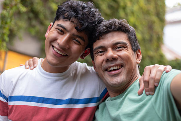 istock Hispanic father and son portrait, hugging and smiling, looking at camera 2244056998