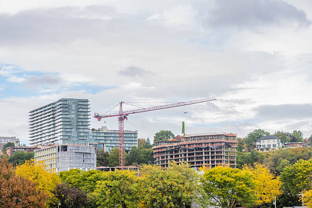 This is a photograph of tall high rise buildings under construction in Edgewater, New Jersey on an overcast, autumn day.