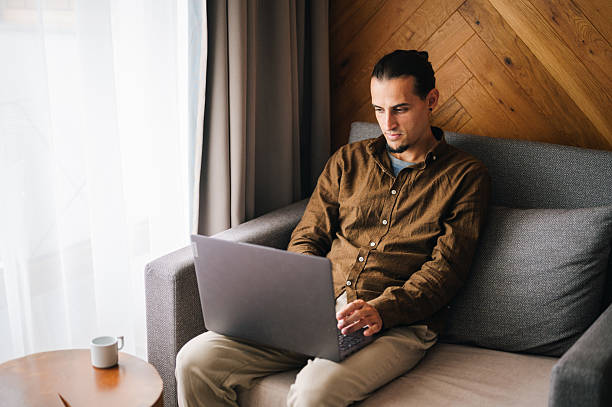 istock Young man in a comfort room working on his laptop. 2244060043