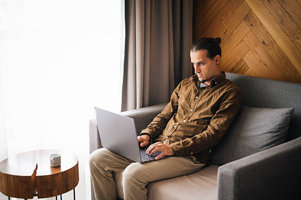 istock Young man in a comfort room working on his laptop. 2244060058