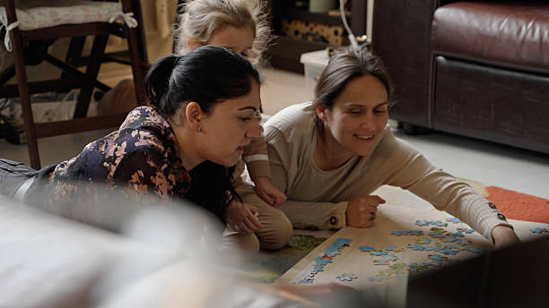 istock Family-Friendly Games. Fun Leisure Time Doing Jigsaw Puzzle 2244060936