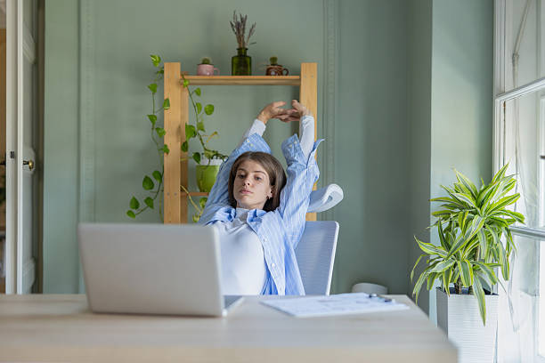 istock Relaxed person stretching at desk surrounded by greenery 2244065963