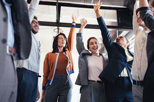 istock Diverse Office Team Celebrates Success and Unity in Bright Open Workspace 2244066199