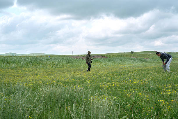 istock Woman and man exploring green rural field 2244066869