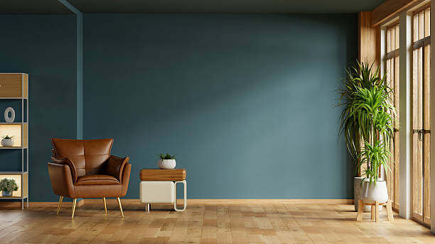 istock A chic and contemporary living room interior with an empty dark blue wall mockup, a comfortable brown leather armchair, a stylish side table- 3D rendering 2244068011