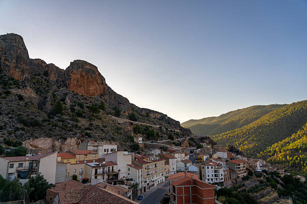 istock Village nestled in a valley beneath rocky mountains. 2244068621