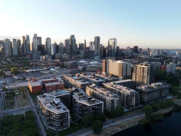 istock Aerial view of modern waterfront district with high-rise buildings and riverside paths, Montreal twilight skyline. g 2244068704