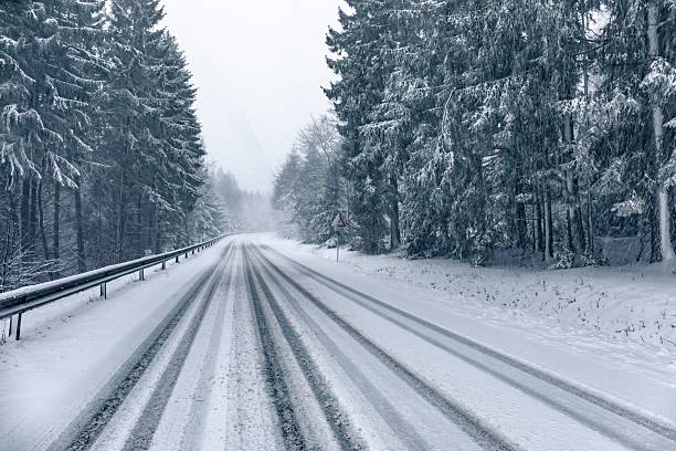 istock Snowy forest road in winter landscape. 2244070571