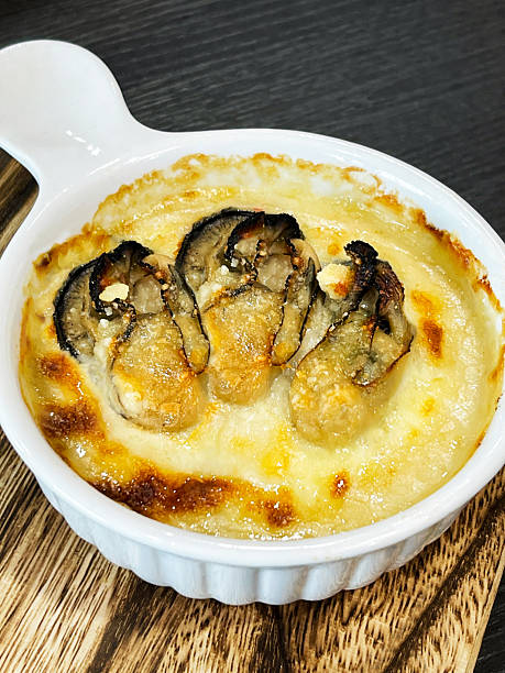 Hot oyster gratin in a ceramic dish