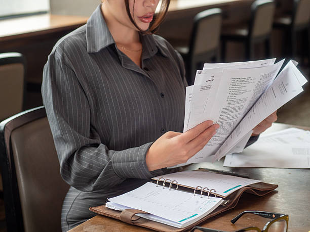 istock Businesswoman Reviewing Documents In Office 2244072766