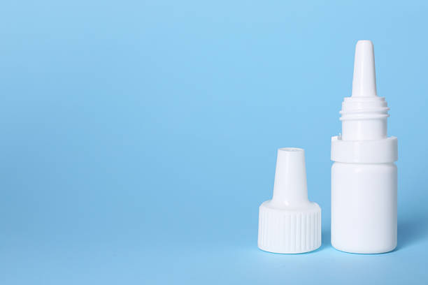 istock Bottle of medical drops on light blue background, space for text 2244072802
