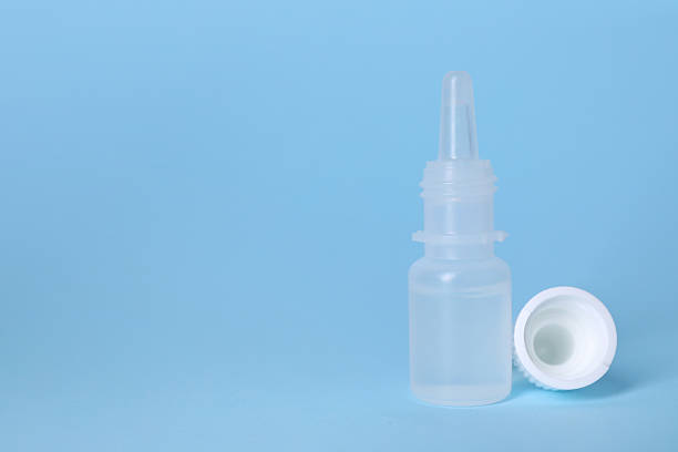 istock Bottle of medical drops on light blue background, space for text 2244072837