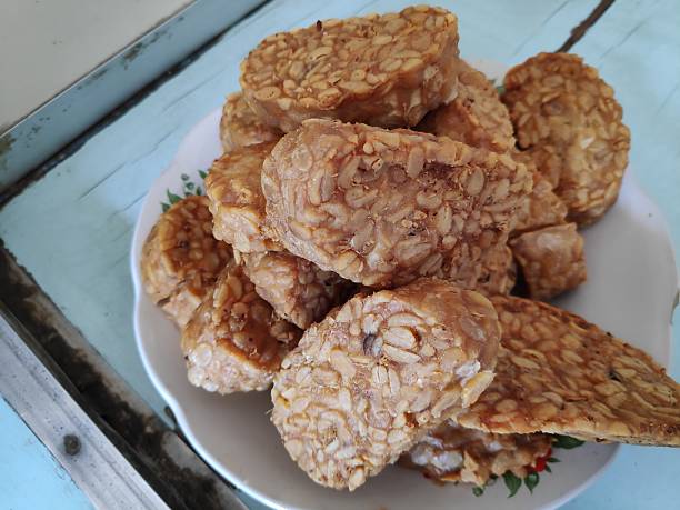 istock Fried tempeh sits piled high on a white plate, a delicious and savory snack ready to be enjoyed 2244073377