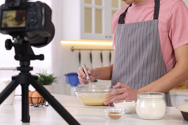 istock Food blogger cooking while recording video in kitchen, closeup 2244076427