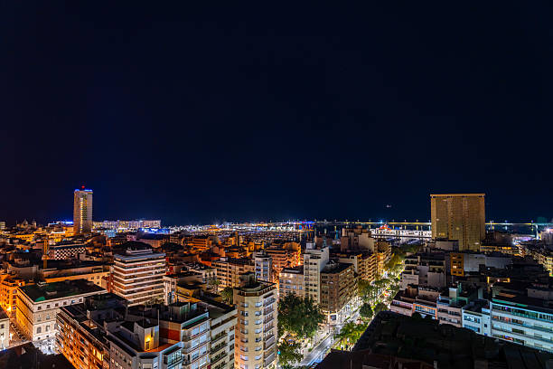 istock Cityscape at night with illuminated buildings and starry sky. 2244076581