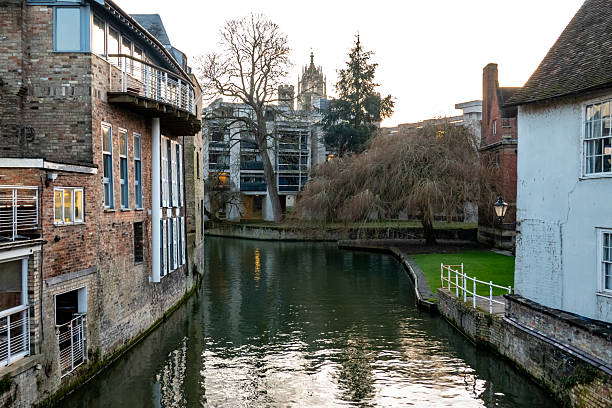 River Cam through Cambridge, reflecting historic buildings and winter trees in this historic English university city.