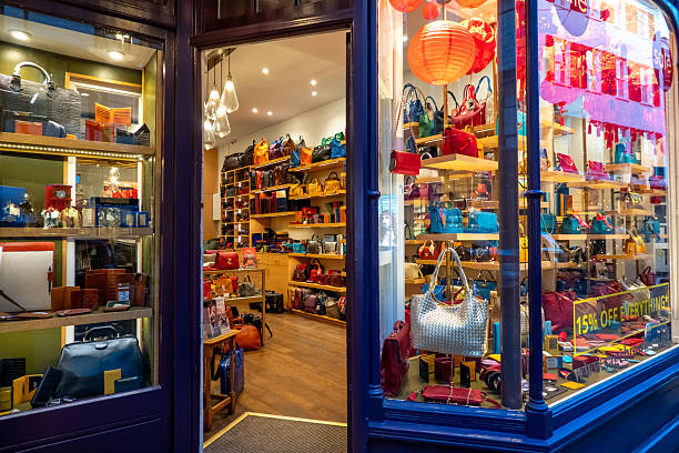 Cambridge, UK - February 02, 2025: A captivating boutique storefront in Cambridge displays an array of colorful leather handbags and wallets for sale.