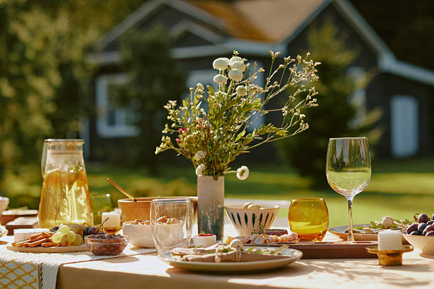 istock Outdoor Summer Table Setting Featuring Fresh Food and Floral Arrangement 2244081928