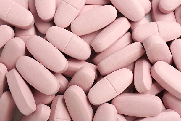 istock Pink vitamin capsules as background, top view 2244083396
