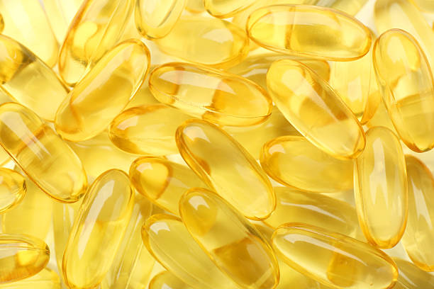 istock Yellow vitamin capsules as background, top view 2244083449