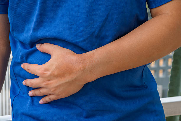 istock Liver-related abdominal pain from alcohol drinking and fatty diet. 2244083471