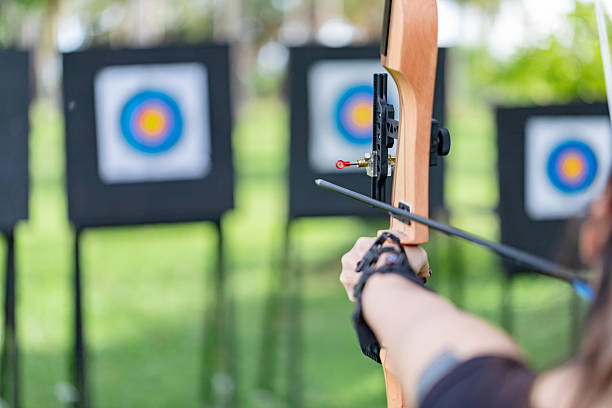 istock Over the Shoulder View of Archer Aiming at Targets Down a Shooting Range 2244086088