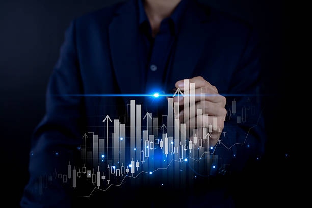 istock Businessman analyzing digital stock market graph showing growth trends and financial data with blue futuristic light, symbolizing investment success and global financial innovation. 2244090743