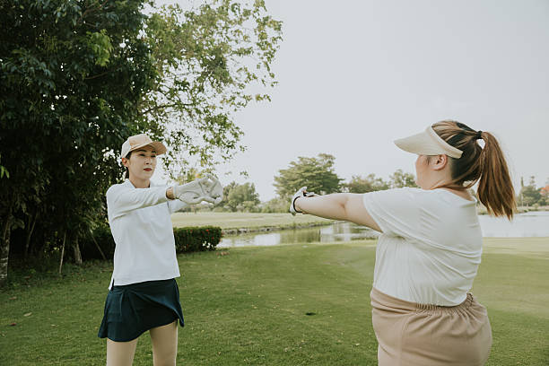 Two Thai golfer are stretching before playing golf at golf club